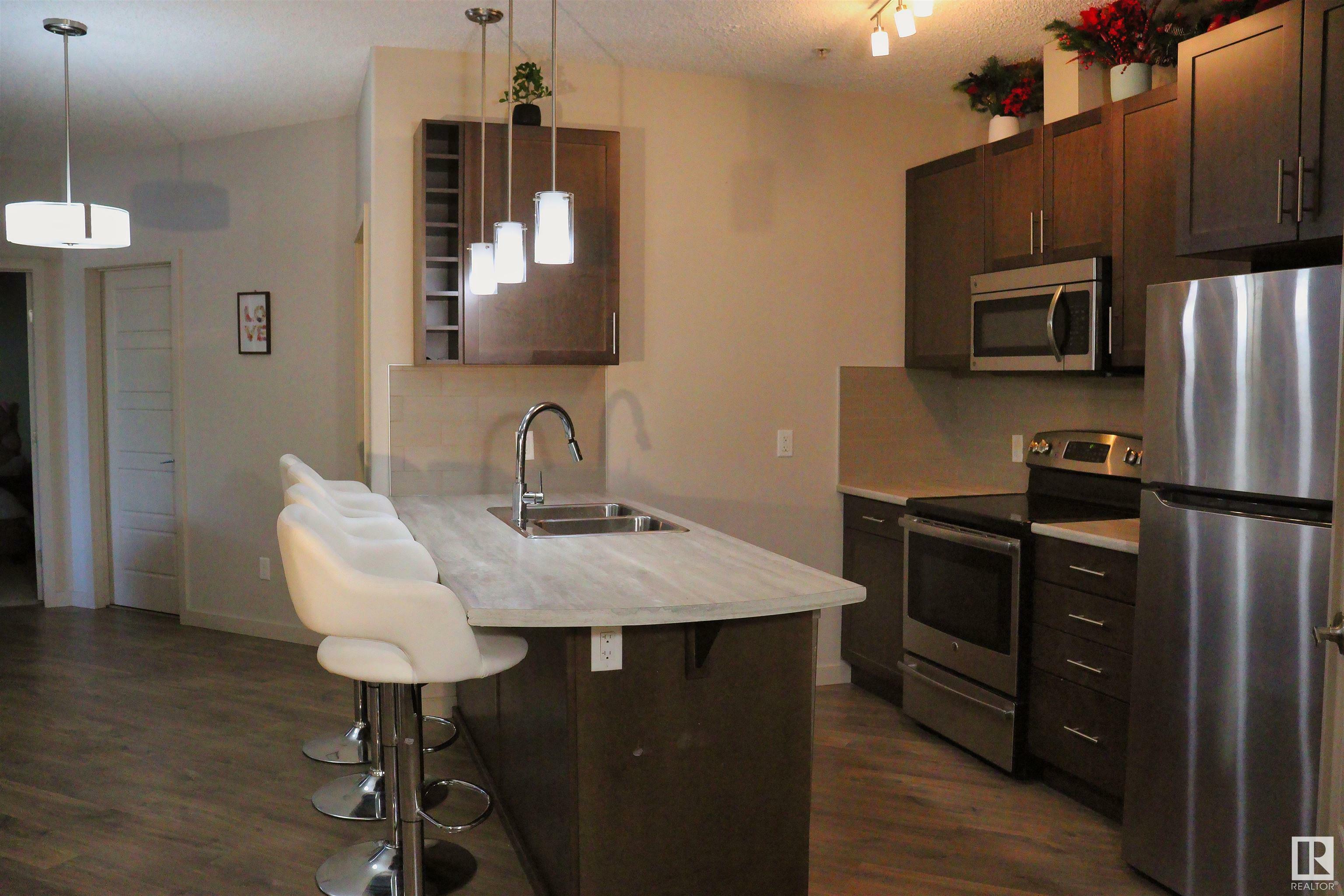 Property Photo: 1144 Adamson Drive SW 110 AB T6W 2X7
