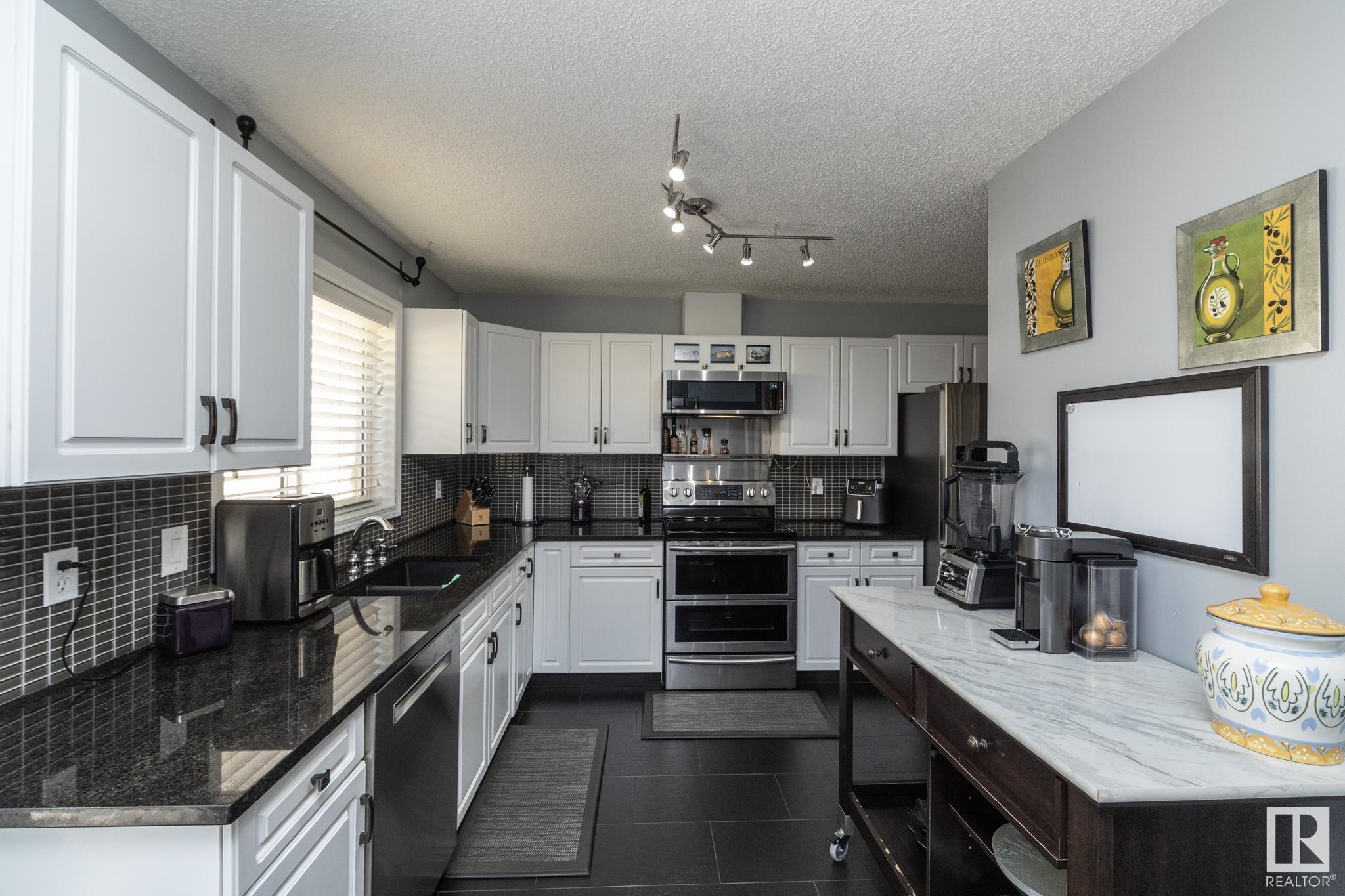 Property Photo:  11717 9B Avenue NW 31  AB T6J 7B7 