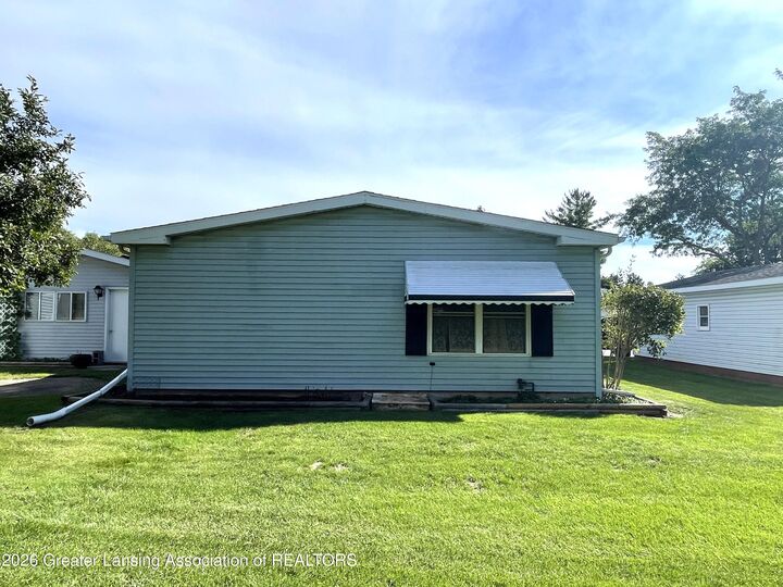 Property Photo:  102 Saint Ives N  MI 48906 