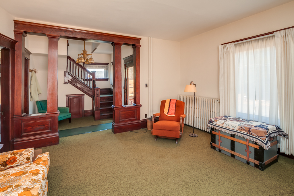 Property Photo: Looking across the living room toward the entry with the stairway beyond. notice all the original woodwork. 1900 G St  WA 98225 